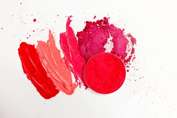 Lipstick and lip gloss, drops and strokes of different shades to create different images in makeup