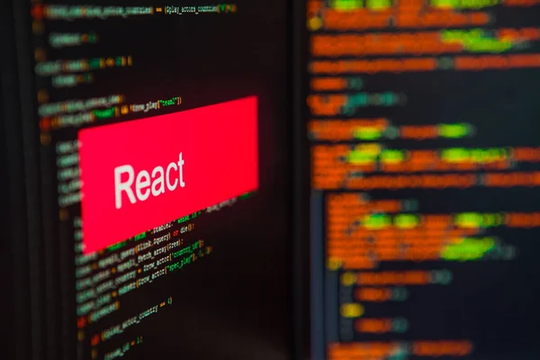 Programming language, React inscription on the background of computer code. — Stock Photo, Image