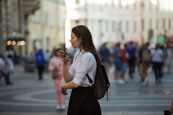 Girl on the street among the crowd of passers-by, photos in the style of surveillance