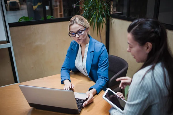 young HR woman interviews a candidate for a job. Business meeting two young women at work discussing the project