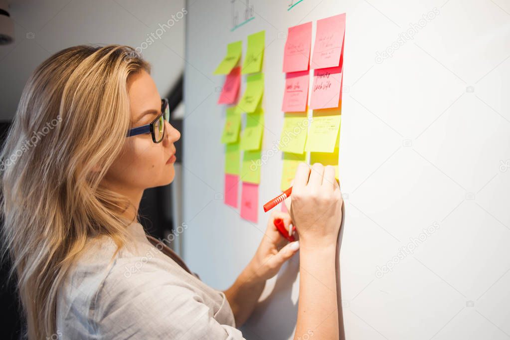 project management, agile methodology. young business woman in the office are working on a startup.