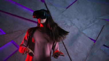 Dikkat et. Vr gözlüklü ve çırpınan saçları olan genç kadın aktif tepki veriyor, oyunda olanlardan korkuyor.