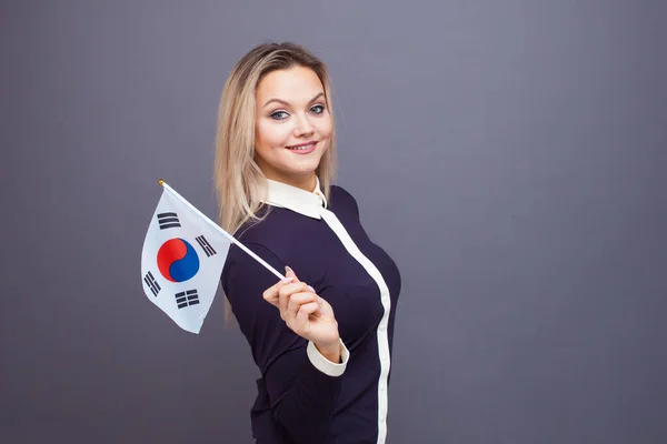 Immigration and the study of foreign languages, concept. A young smiling woman with a Republic of Korea flag — Stock Photo, Image