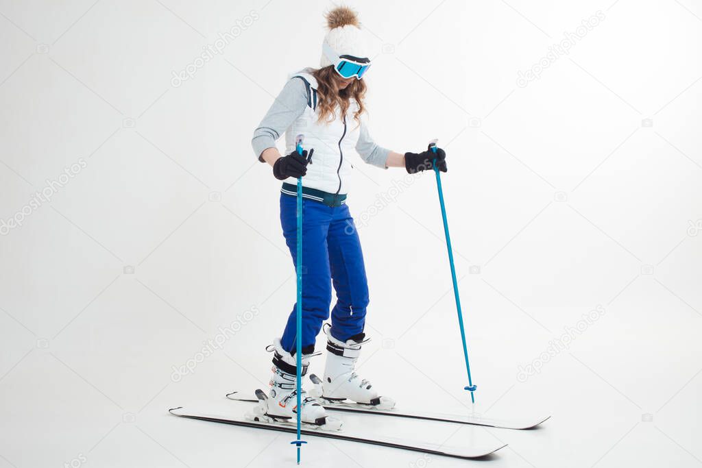 young woman goes skiing. Skier maneuvers on mountain skis, photos on a white background in the Studio,