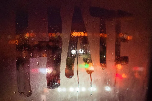 Hate, negative emotions. Inscription on the fogged glass, night city — Stock Photo, Image