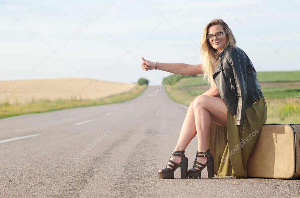 Portrait of a lady standing by the road.