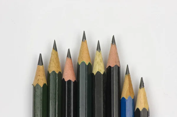 Pencil with sharpening on white paper background. — Stock Photo, Image