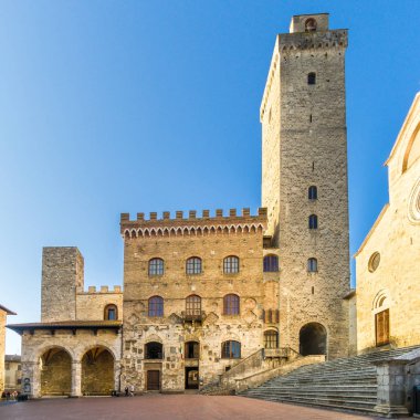 San Gimignano, İtalya - Eylül 21,2018 - görünümdür Duomo yer ile Belediye Gimignano.San San Gimignano için yapılan bina, Toskana bölgesindeki Siena eyaletinde küçük duvarlı Ortaçağ tepe şehirde.