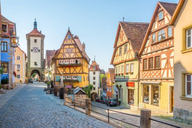 ROTHENBURG OB DER TAUBER,GERMANY - AUGUST 09,2020 - Siebersturm and Kobolzeller Towers in the streets of Rothenburg. Rothenburg is well known for its well-preserved medieval old town. clipart