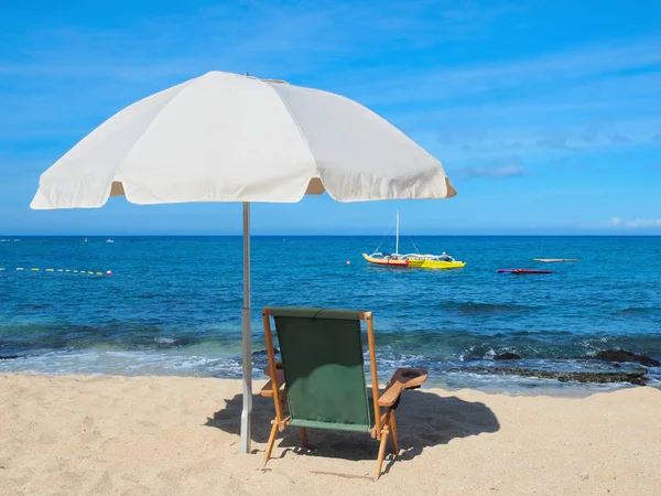 Пляжный стул с зонтиком на берегу — стоковое фото