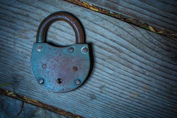 Closeup of vintage padlock on wooden background