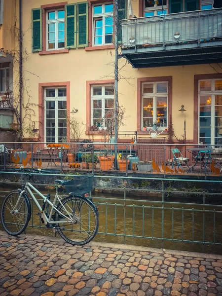 the edge of an urban river with houses