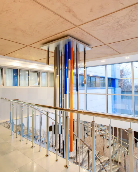 Metallic huge High-tech chandelier in an office building