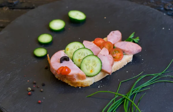Children\'s ham sandwich made in the form of fish. Option of children\'s serving