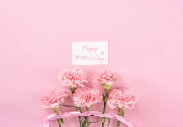 Top view, flay lay, copy space, close up, mock up, mothers day thanks design concept. Beautiful fresh blooming baby pink color carnations isolated on bright pink background — Stock Photo, Image