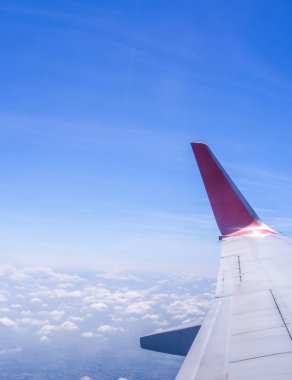 Bussiness ve seyahat konsepti. Güneş ışığı ile güzel mavi gökyüzü ve bulut ile uçak kabin içinde pencereden havadan görünümü, kopya alanı, üst görünüm