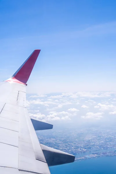 Bussiness and travel concept. Aerial view through window inside aircraft cabin with beautiful blue sky and cloud with sunlight, copy space, top view