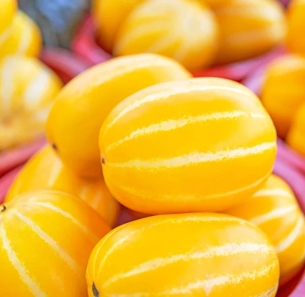 Delicious korean stripe yellow melon fruit food in red plastic basket at tradition market afternoon, Seoul, South Korea, harvest concept, close up. — Stock Photo, Image