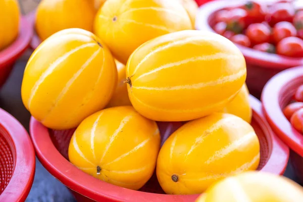 Delicious korean stripe yellow melon fruit food in red plastic basket at tradition market afternoon, Seoul, South Korea, harvest concept, close up. — Stock Photo, Image