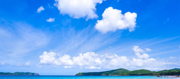 Beautiful amazing gold colored sandy beach with soft waves isolated with sunny blue sky. Concept of tropical calm tourism idea, copy space, close up