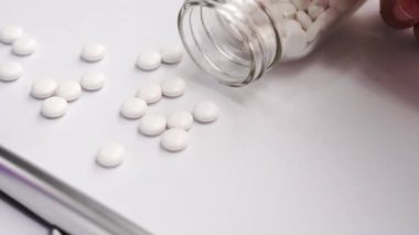 Tıbbi Konsept - Beyaz bilgisayar klavyesi ve yanında ilaçlar üzerinde mavi stetoskop ile Doktor ofisi çalışma masası. Kamyon sol, yakın çekim, makro.