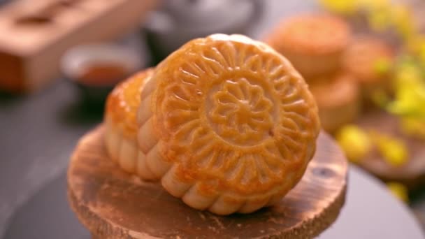 黒いスレートの背景にお茶と花と木製のトレイに回転美しい月のケーキ 中国の伝統的な中秋祭りのコンセプトビデオ — ストック動画