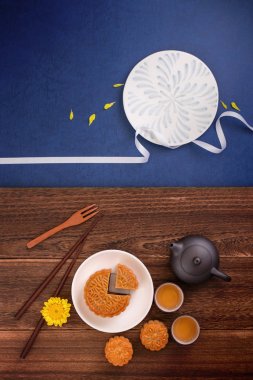 Creative Moon cake Mooncake design inspiration, enjoy the moon in Mid-Autumn festival with pastry and tea on wooden table concept, top view, flat lay clipart