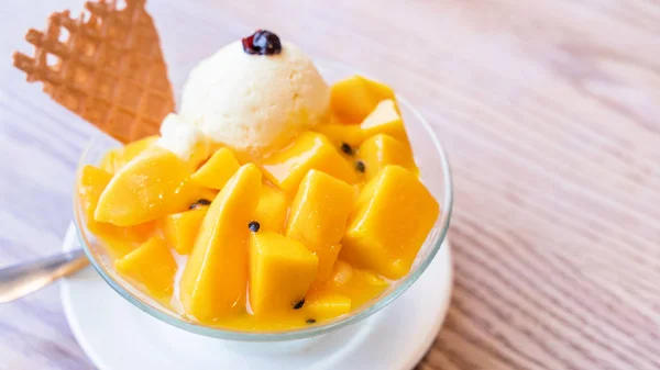 Fresh mango shaved ice with a scoop of ice cream and juice sauce in summer restaurant, lifestyle, popular food in Taiwan, close up.