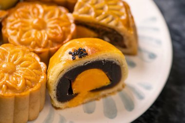 Sonbahar ortası festivali için koyu arkaplanda yumurta sarısı pastası. Çin yemeği konsepti, yakın plan, boşluğu kopyala.