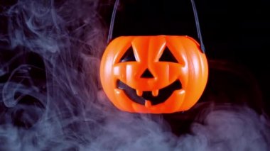 Halloween kavramı - koyu siyah arka plan, korku ve korku ruh hali, yakın izole etrafında beyaz duman ile plastik kabak fener hareketli.