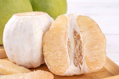 Taze soyulmuş pomelo, pummelo, greyfurt, parlak ahşap masa arka plan üzerinde shaddock. Sonbahar Ortası Festivali için mevsim meyveleri, yakın çekim, kopyalama alanı.