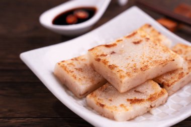 Lezzetli şalgam kek, soya sosu ve yemek çubukları ile restoranda Çin geleneksel yerel yemek turp kek, yakın, kopya alanı.
