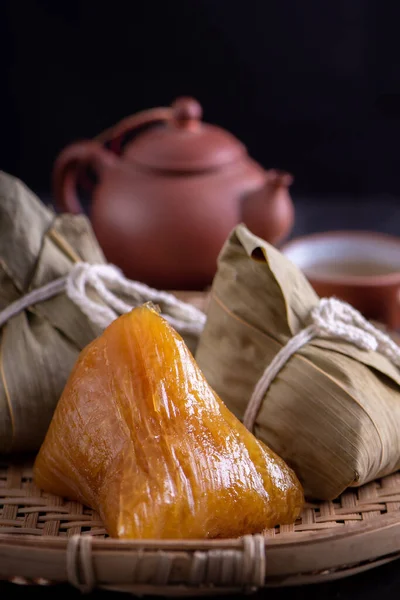 Alkaline rice dumpling zongzi - Traditional sweet Chinese crystal food on a plate to eat for Dragon Boat Duanwu Festival celebration concept, close up.