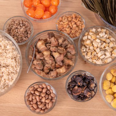 Making Rice dumpling - wrapping Chinese zongzi food on table at home for Dragon Boat Festival celebration, close up, lifestyle.