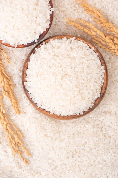 Raw rice in a bowl and full frame in the white background table, top view overhead shot, close up