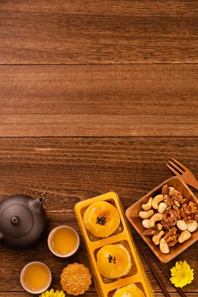 stock image Moon cake for Mid-Autumn Festival, delicious beautiful fresh mooncake on a plate over dark wooden background table, top view, flat lay layout design concept.