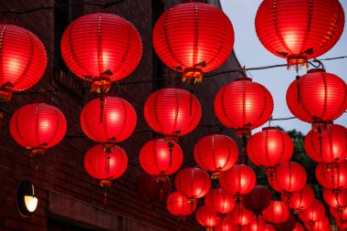 Beautiful round red lantern hanging on old traditional street, concept of Chinese lunar new year festival in Taiwan, close up. The undering word means blessing. clipart