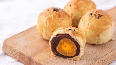 Ay pastası sarısı pastası, Sonbahar Festivali tatili için ay çöreği, fotokopi alanı olan parlak ahşap masa üzerinde üst görünüm tasarım konsepti.