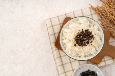 Baharatlı deniz yosunu ve susamlı bir kase kabarık beyaz pirinç..