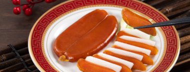 Delicious fresh mullet roe with white radish slices and garlic sprout for Chinese lunar new year gift basket box, holiday celebration.