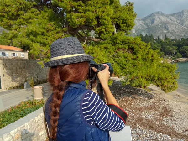 Woman photographer Nature photographer shooting the sea.