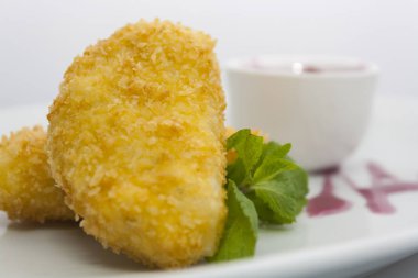 beyaz bir tabakta üzüm sosu ve nane ile patates köftesi