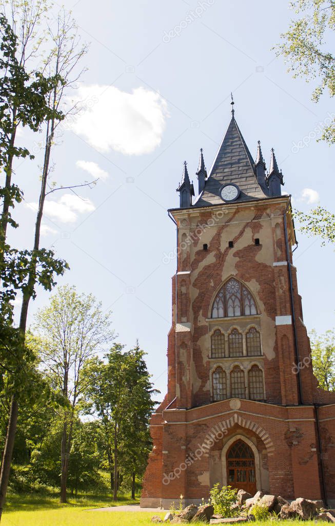 Tower of the old castle of red bricks with a crack in the Pushkin town, Russia