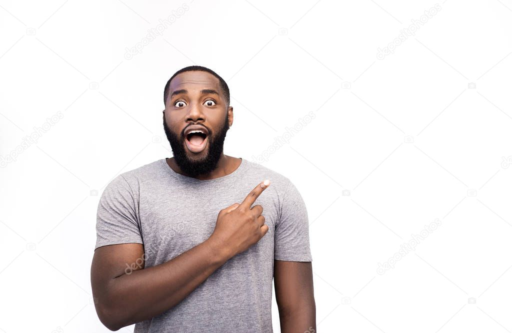 shocked African American man pointing on something isolated on white
