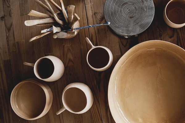 Cups made of clay handmade dishes, dishes from environmental materials. Cups for coffee or tea. Cinema film picture. In workshop of the master of sculpture. ECO friendly. Trendy movement in dishes