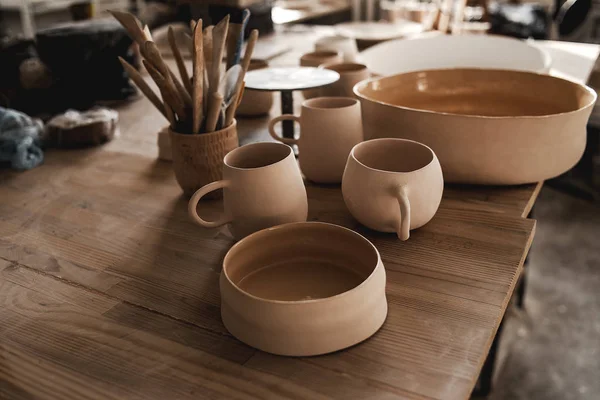 Cups made of clay handmade dishes, dishes from environmental materials. Cups for coffee or tea. Cinema film picture. In workshop of the master of sculpture. ECO friendly. Trendy movement in dishes