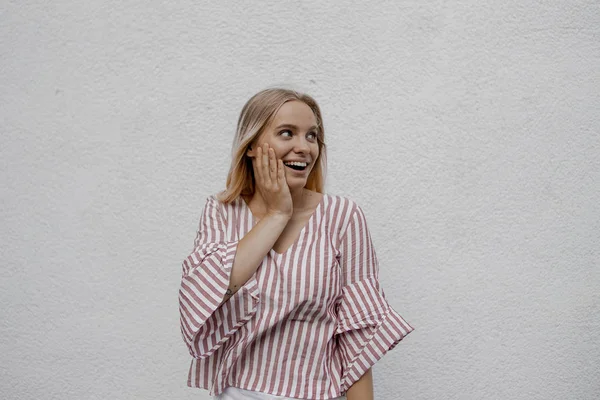 Surprised Attractive Blonde Woman Touching Face Looking Away Grey Wall — Stock Photo, Image