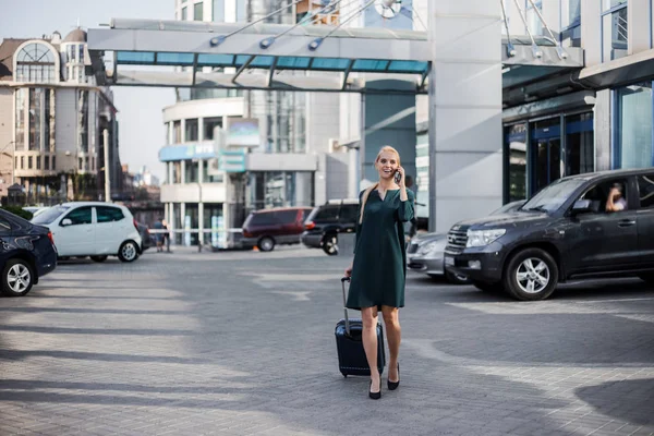 Business woman at international airport moving to terminal gate for airplane travel trip. Mobility concept and aerospace industry flight connections.
