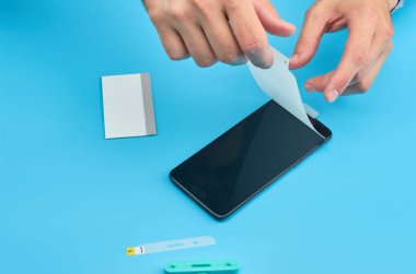 Akıllı telefon için kırık temperli cam ekran koruyucusu yerine adam.
