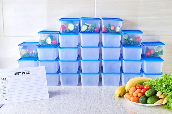 A meal plan for a week on a white table among set of plastic containers for food and food. Proper nutrition during the week.